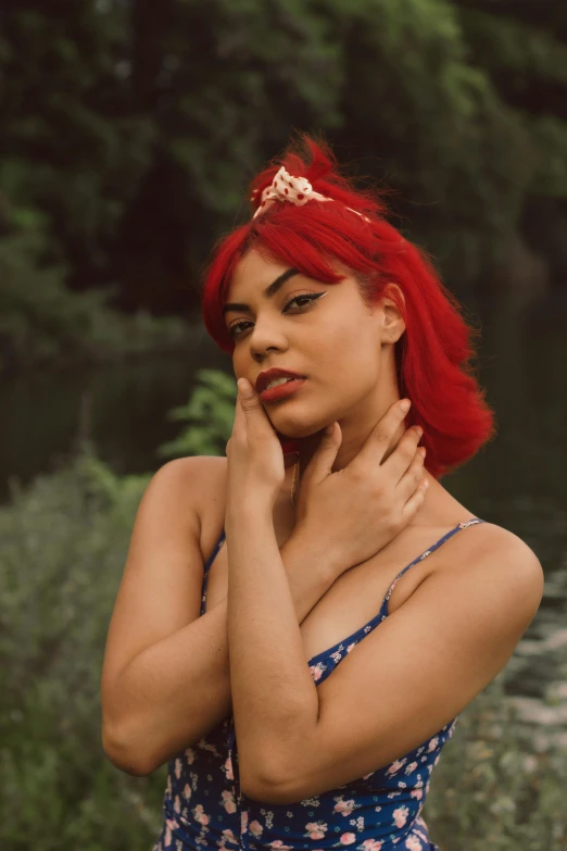 a woman with red hair is standing outside