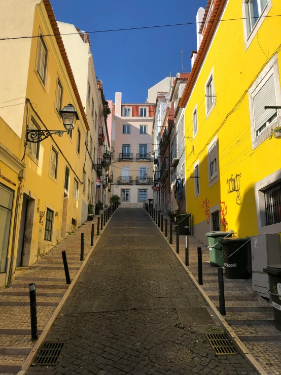 a very narrow street between many different buildings