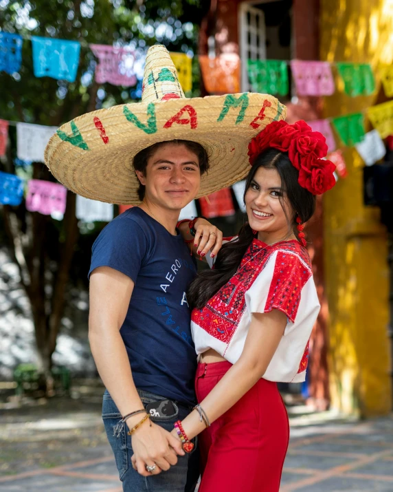 a man and woman in mexican outfits posing for a po