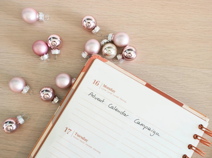 note pad with writing and many ornaments on table