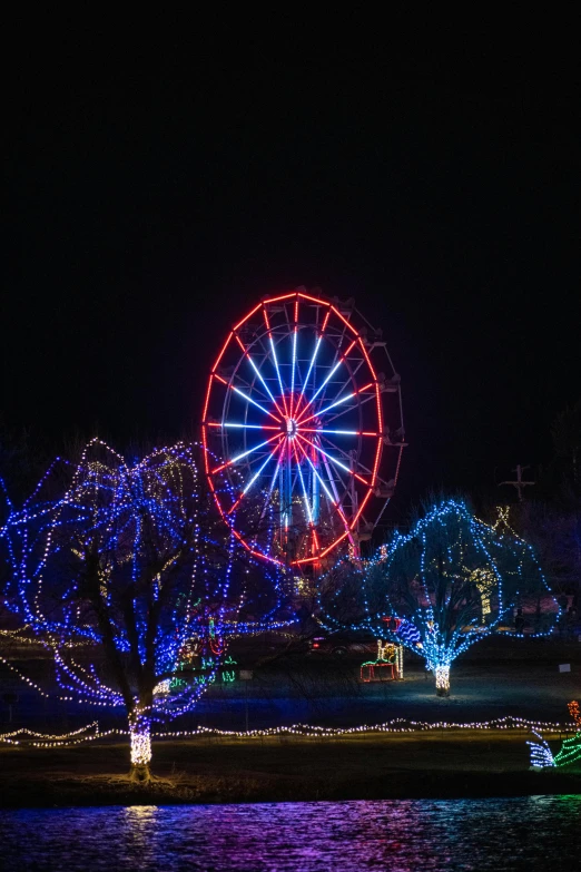 many christmas lights around a ferris wheel at night