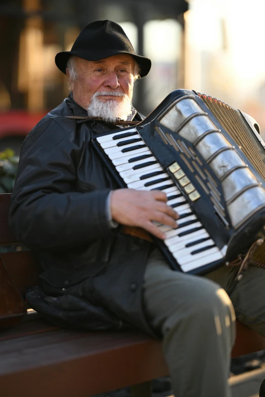 a man is sitting on a bench with a piano