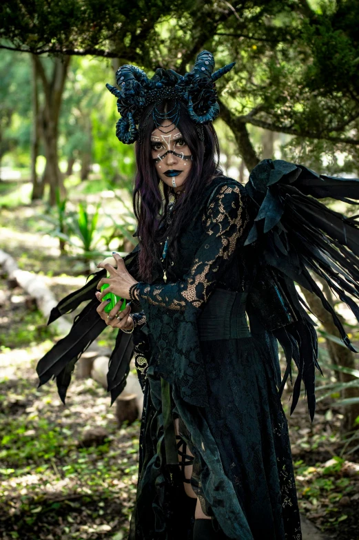 a woman with long hair wearing black dress with feathers