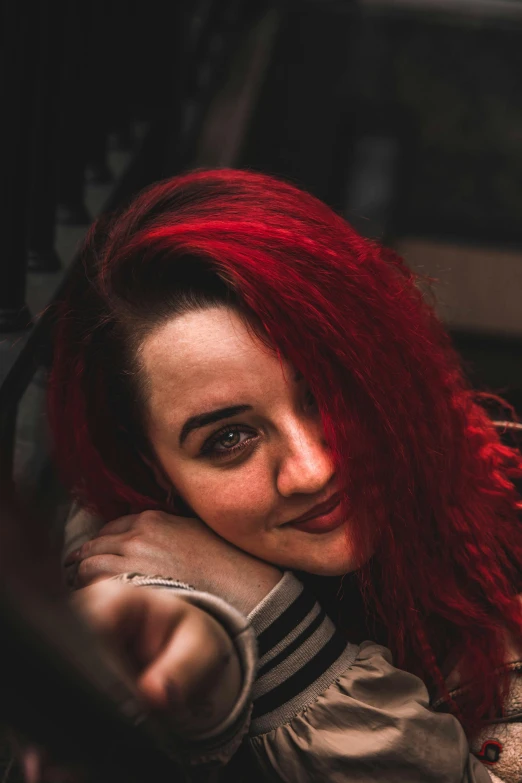 a person with red hair on posing for a picture