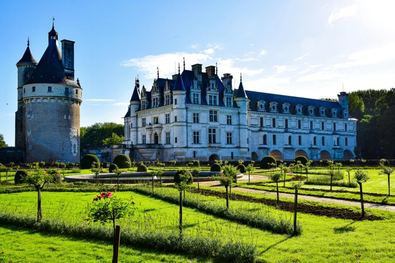 the main building of an elegant castle with gardens on the front