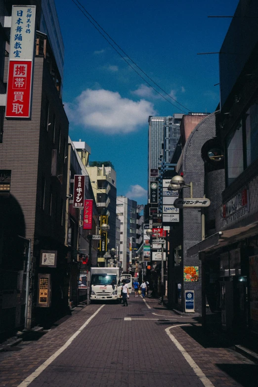 an empty city street with people on the side