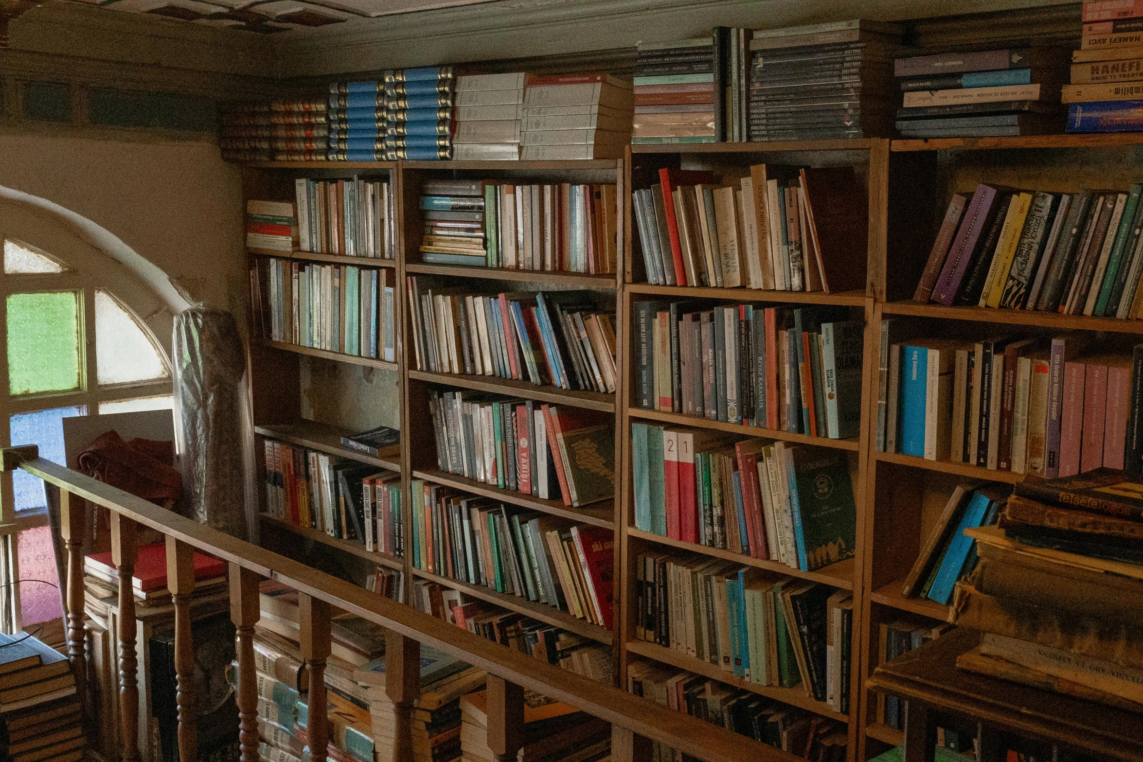 some books on shelves that have been placed on the wall