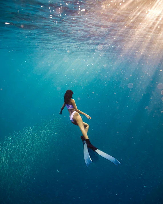 a woman is floating in the clear water
