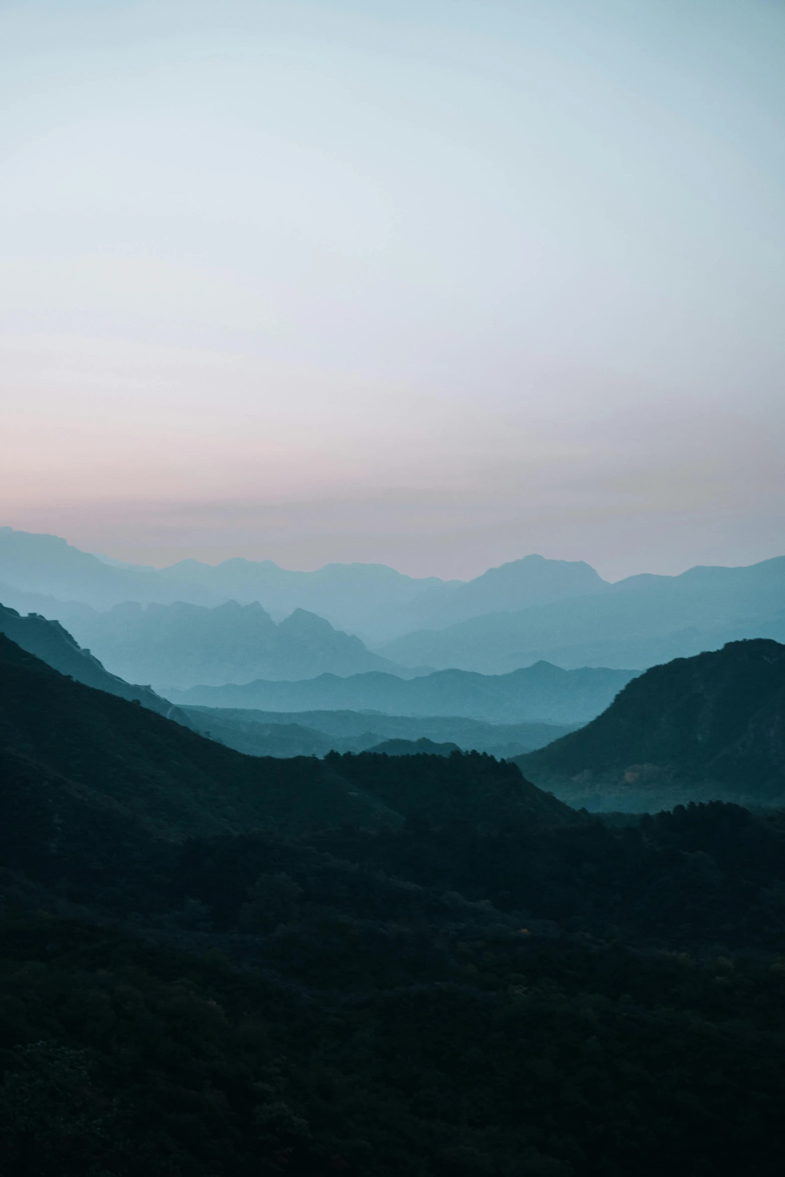 the mountain tops are illuminated at night and are glowing pink