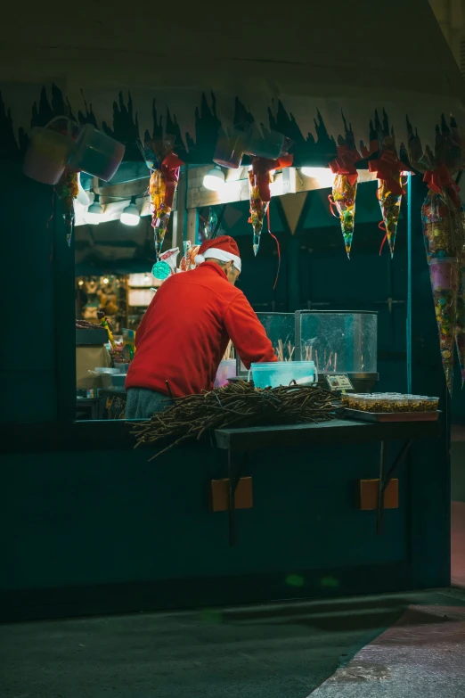 a man in santa hat preparing food on a counter