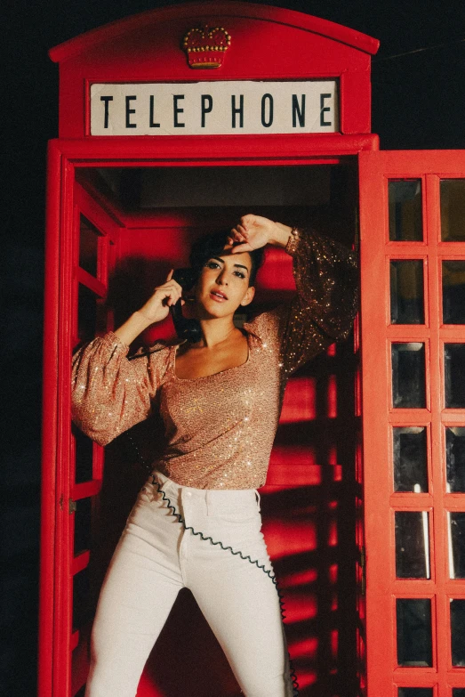 a woman in tights poses in front of a telephone booth