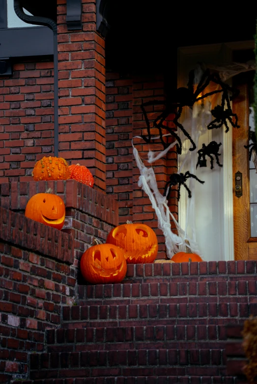 halloween decorations of pumpkins sitting on a brick stair