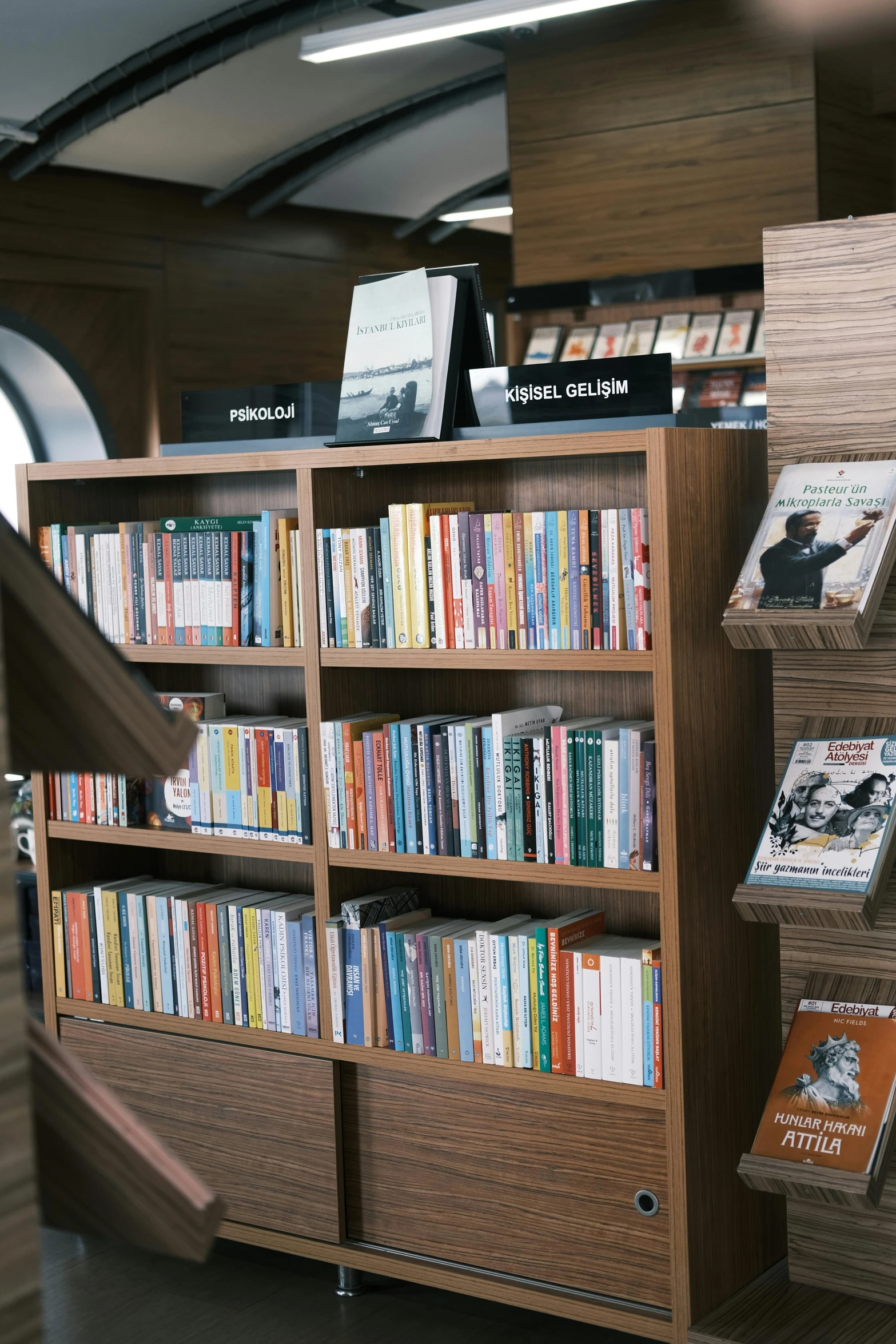 a shelf filled with lots of books on top of a wooden floor