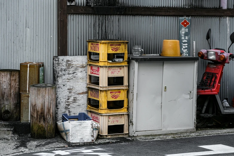 old, yellow, crates sit on the side of the street