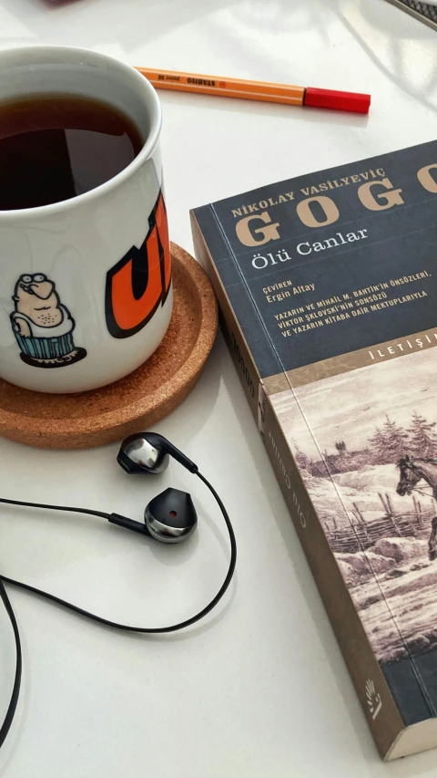 book on a table with coffee and headphones