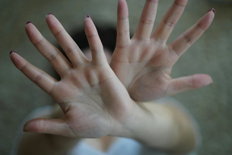 a woman's hands are being raised with fingers out