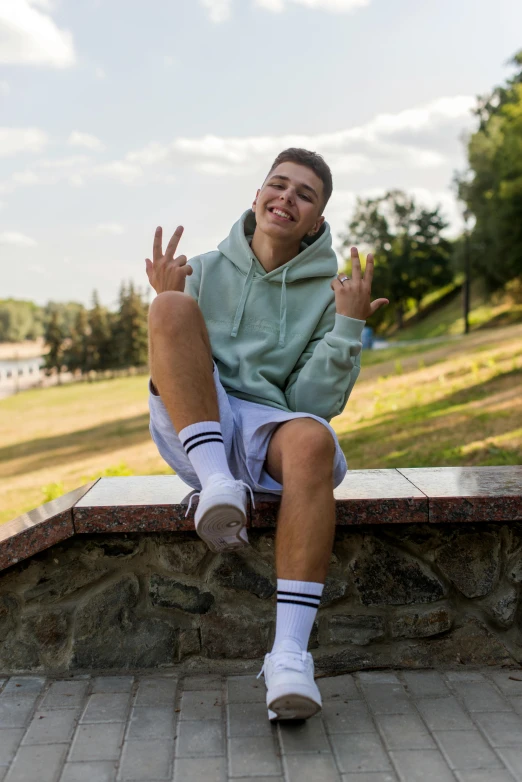 a man in the park is sitting on some bricks