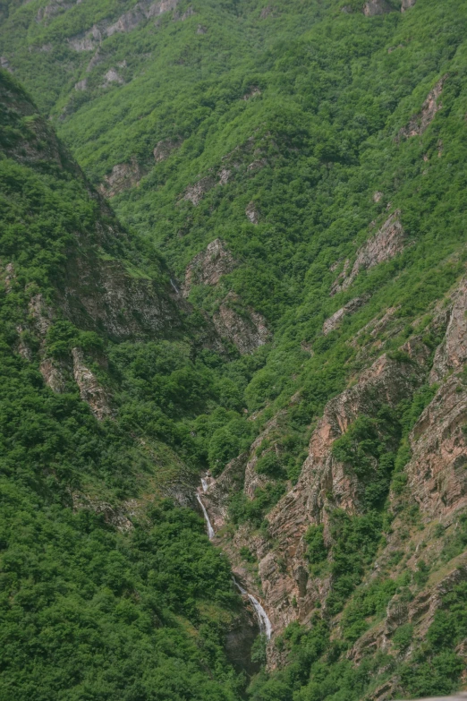 a valley with grass and rocks on the side