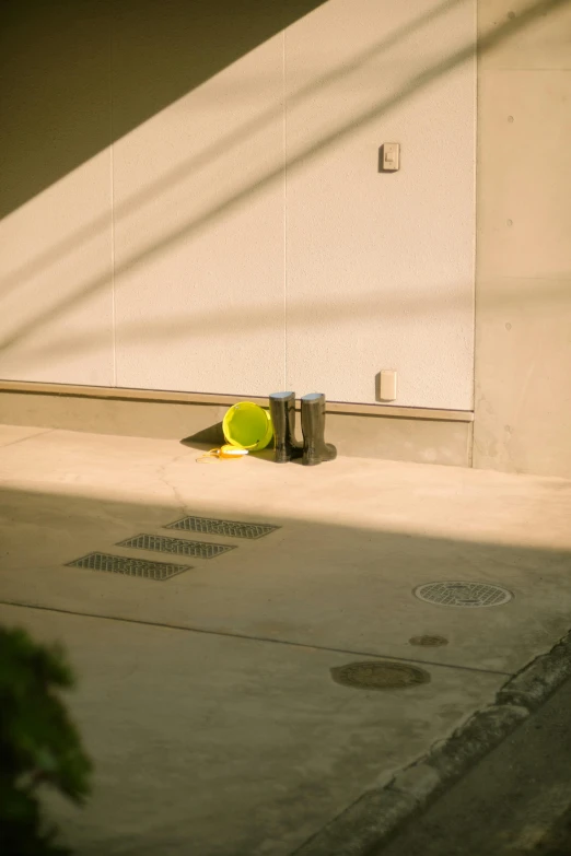 a yellow object leaning up against a building