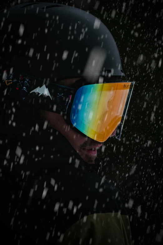 the skiers goggle is multicolored and snowflakes