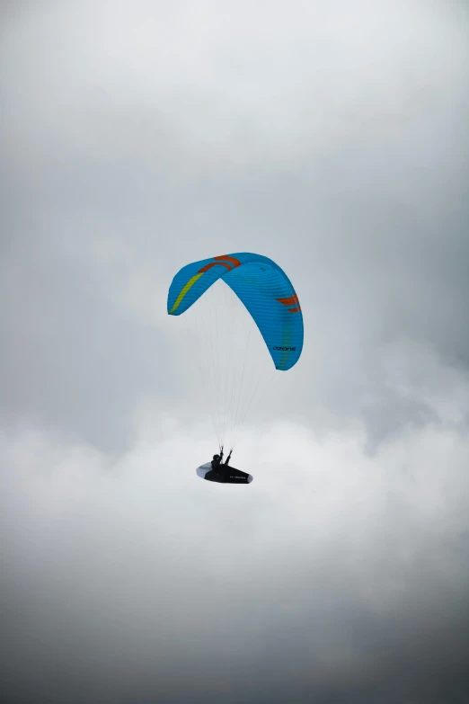 the parasailer is flying high into the air