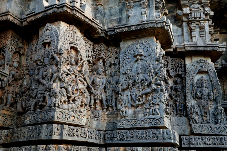 carved indian deities are at the entrance to a building