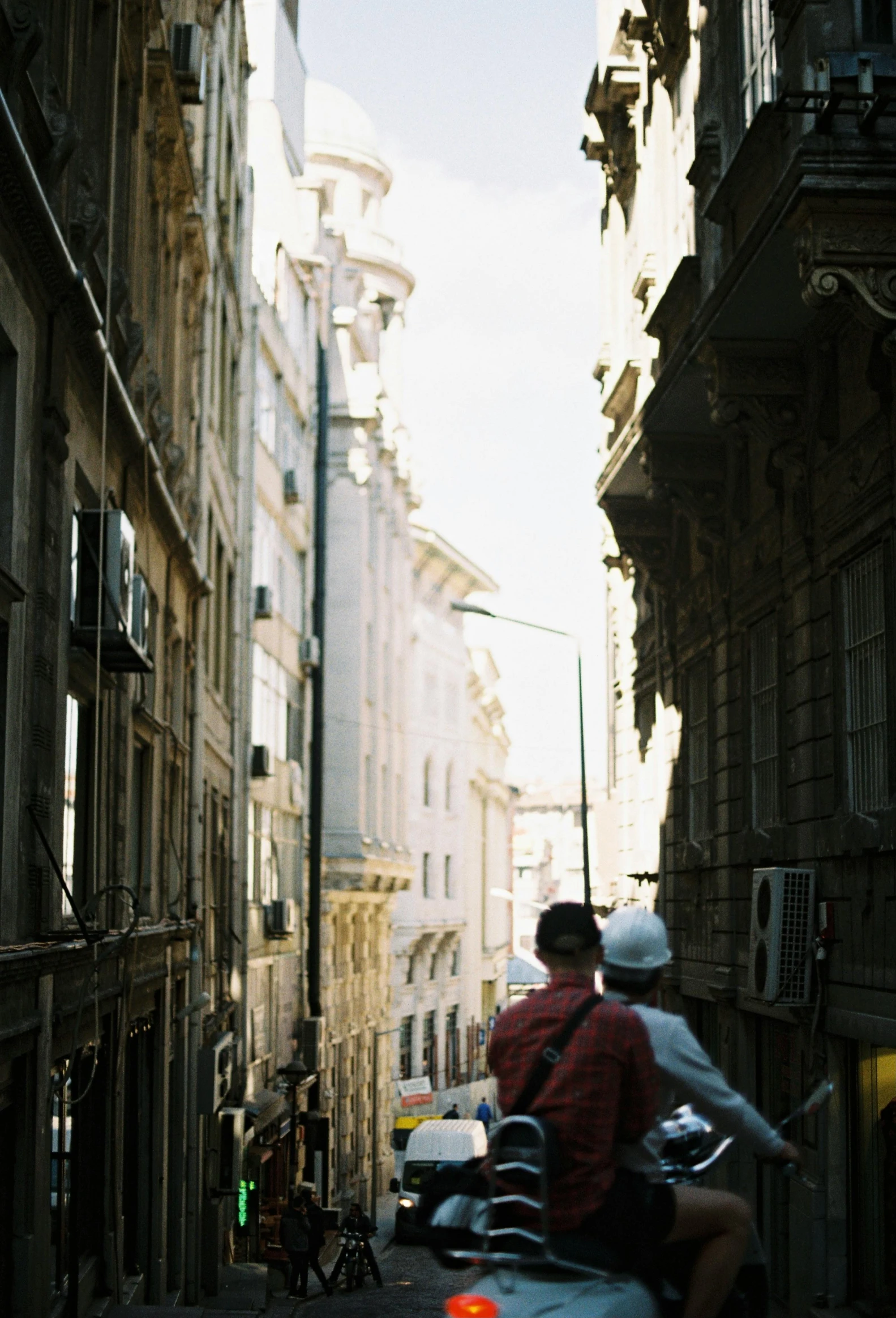 a couple of people on scooters in the street