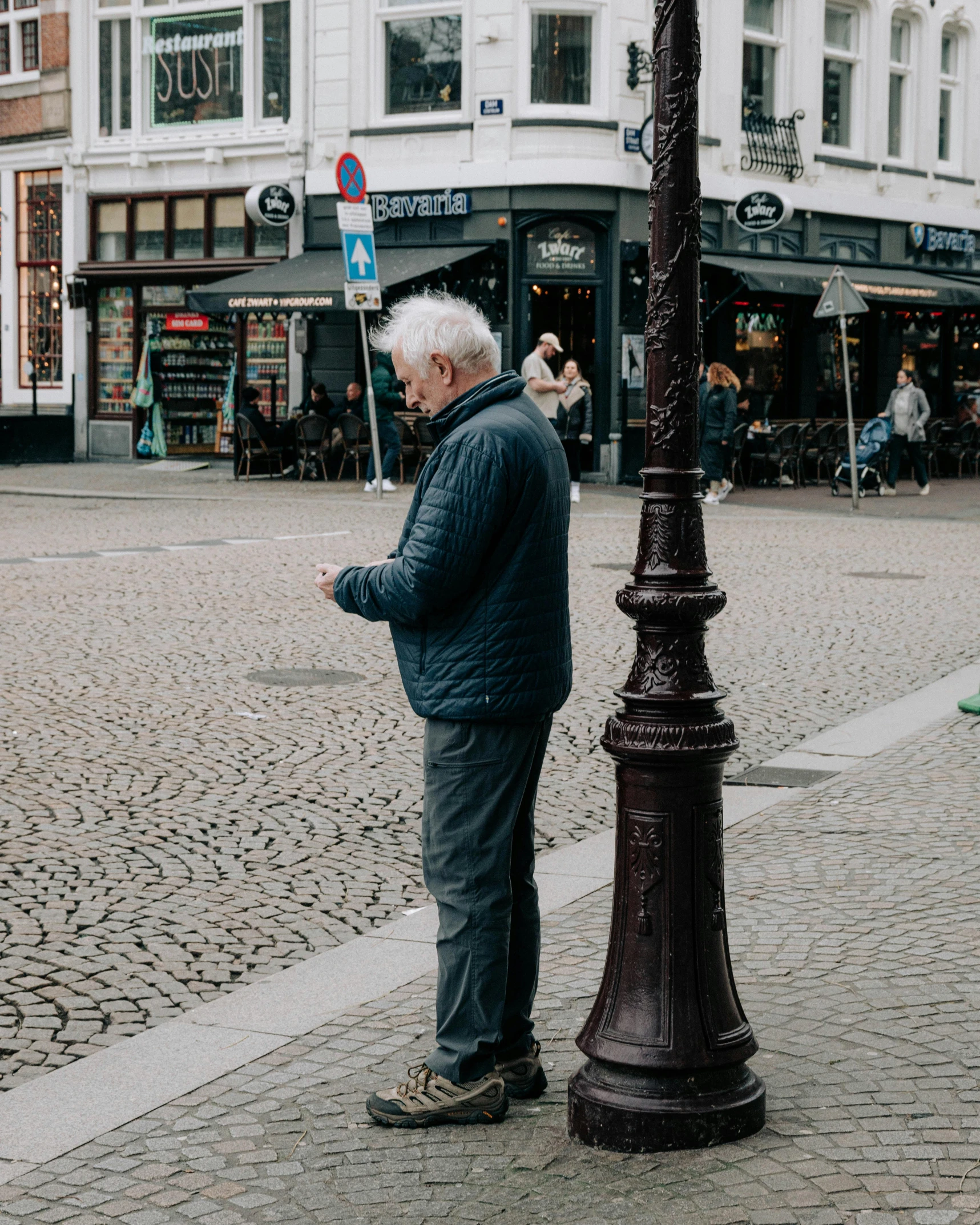 an elderly man in front of a traffic light on the street