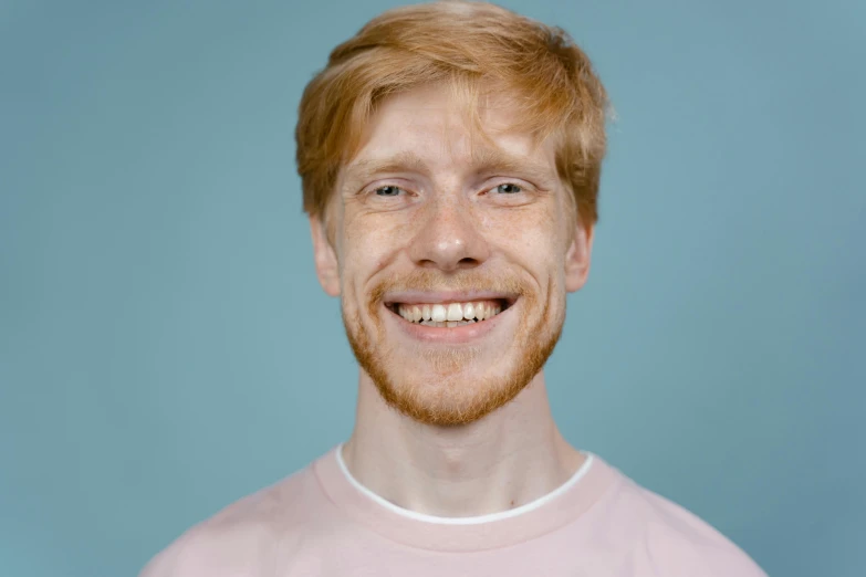 a man with red hair has his face partially up