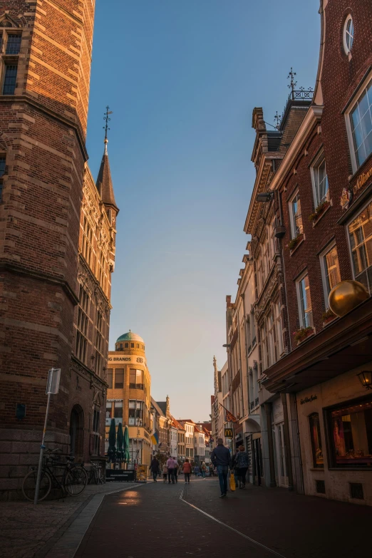 people walking along a street in an old european setting