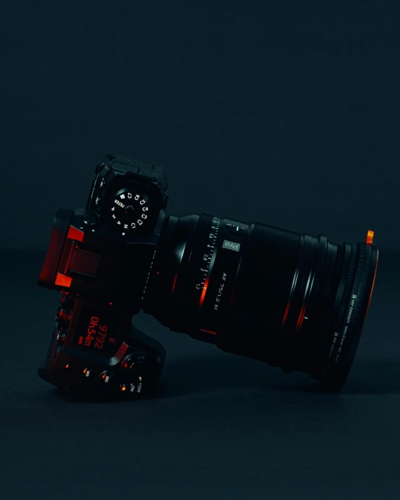 a camera sitting upright with a lens attached to the camera