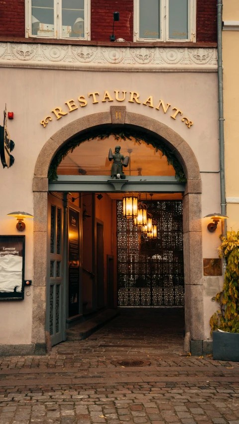 the front entrance to an upscale el at dusk
