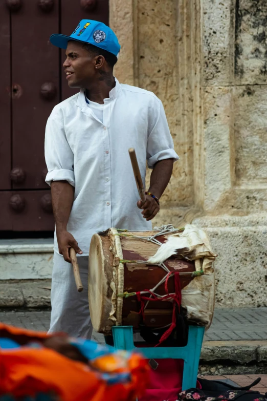 man playing on large musical instrument near old building