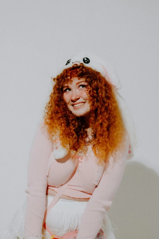 a woman sitting in a cat costume on a stool