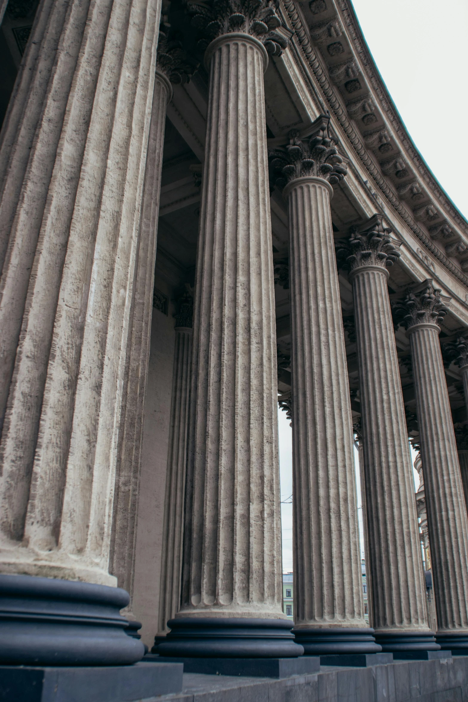 a building with multiple stone pillars and steps