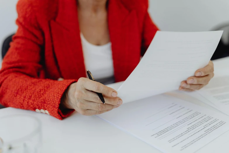 a lady sitting at a table with a notebook