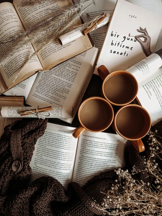 a pile of books sitting on top of an open book