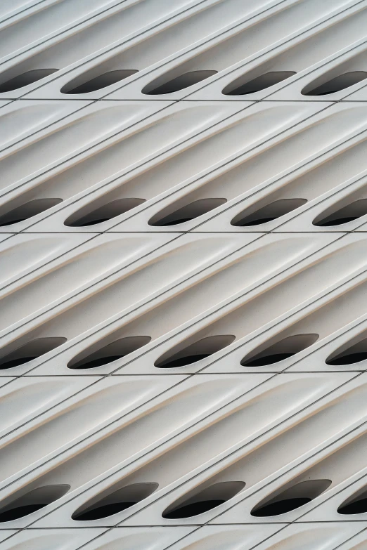 many white windows behind metal strips on the building