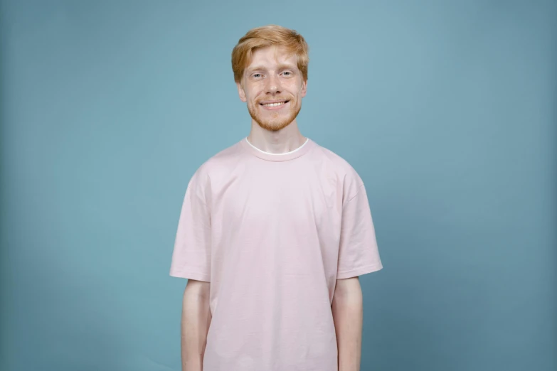 a redhead boy smiles with a toothbrush in his hand