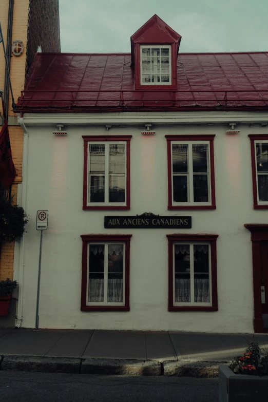 a tall building with a red roof is near a street