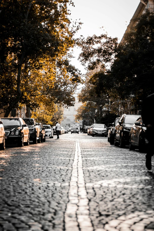 people walking down the street, while a car approaches