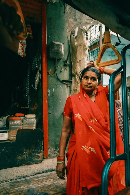 a woman in red walking down a street