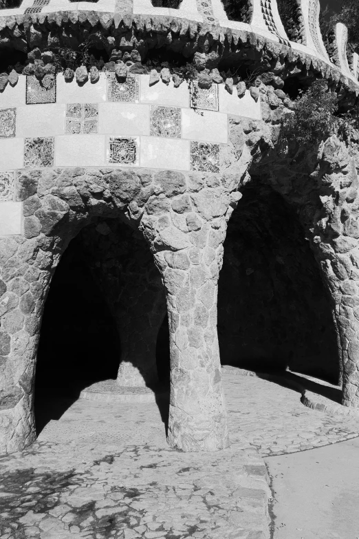 an old wall with three pillars with a clock