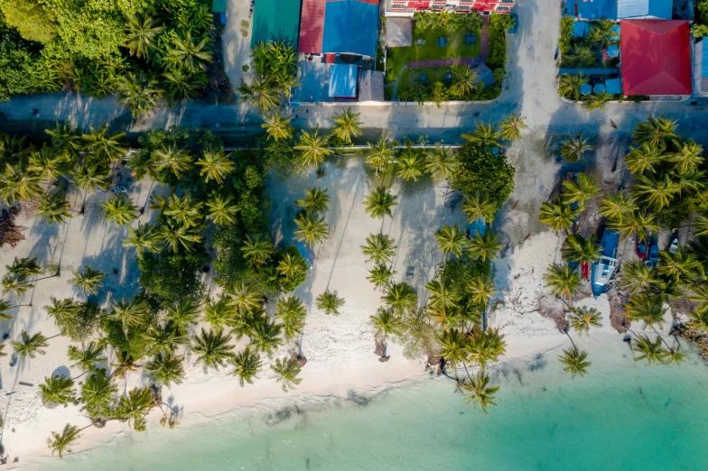 an aerial view of a small beach resort and turquoise waters