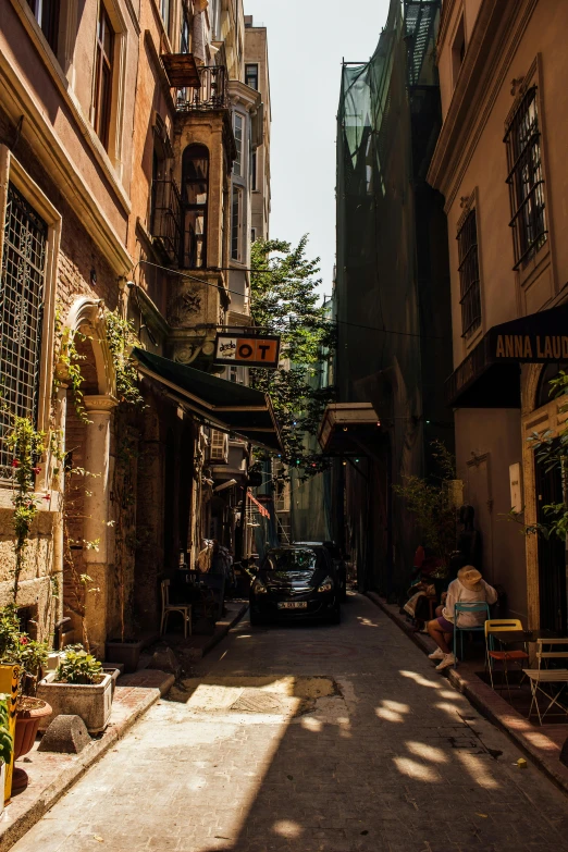 a car is driving down an alley way