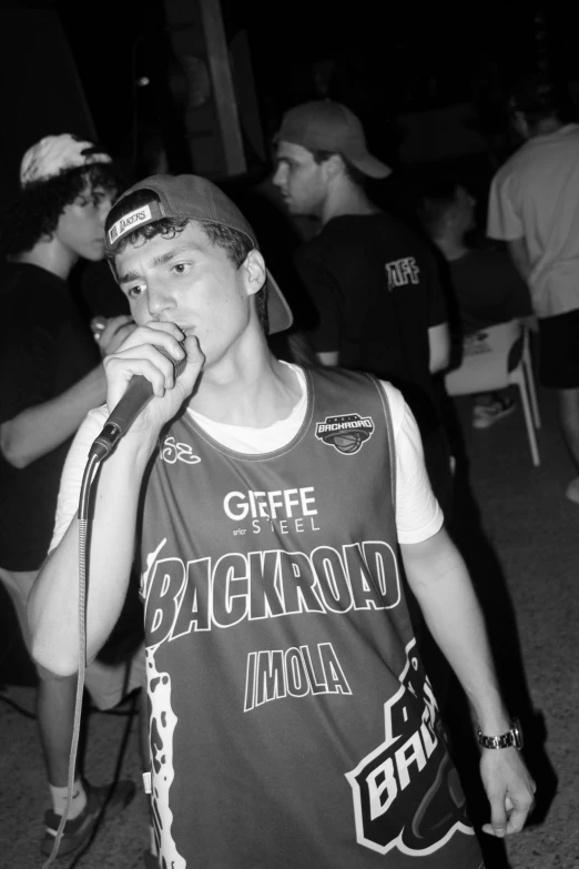 a young man holding a microphone near his mouth