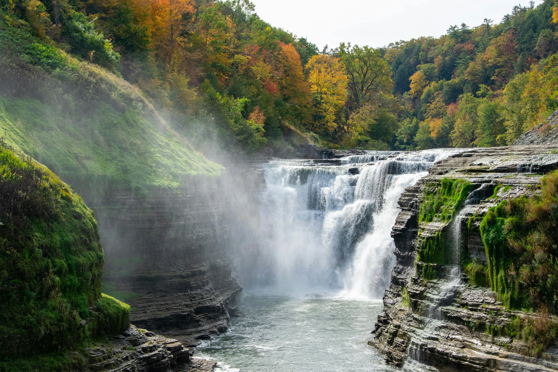 a wide waterfall with people watching it