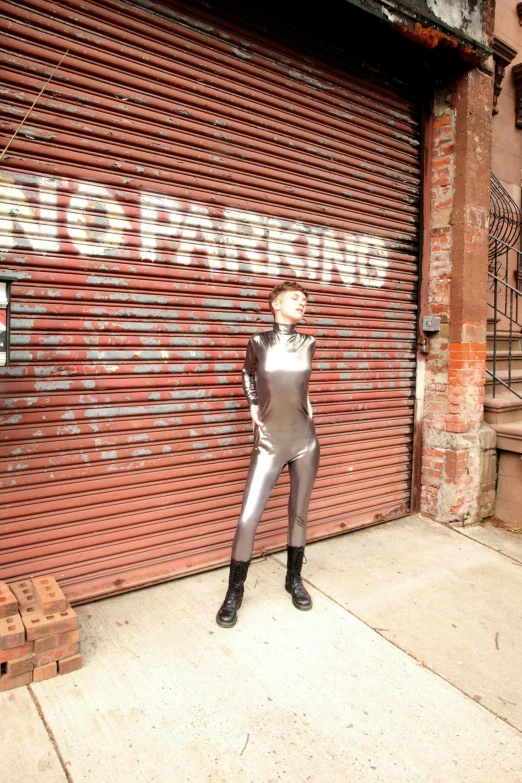 a man in costume is posed on a sidewalk