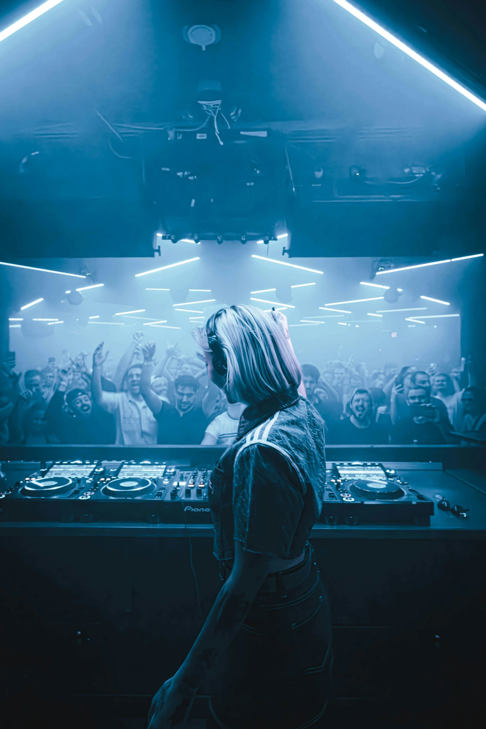 a dj mixing in front of his mixer on stage