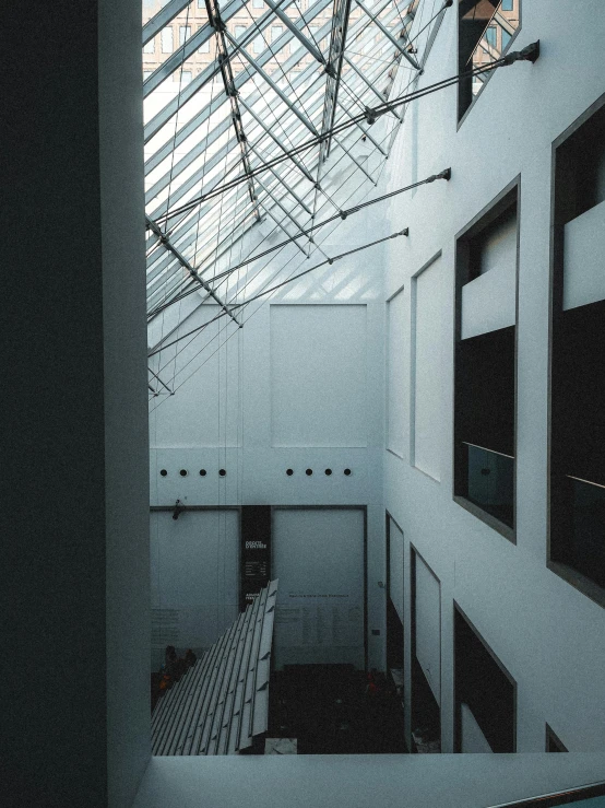 a modern looking room with lots of glass and metal ceiling